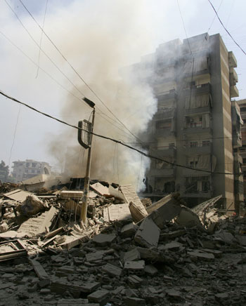 Smoke billows from the rubble of destroyed buildings attacked by Israeli air strikes in the southern suburbs of Beirut (AFP)