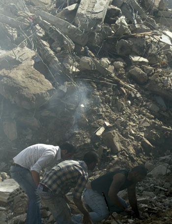 Lebanese rescue workers search for bodies amid the rubble of buildings destroyed the previous day by Israeli bombardment (AFP)