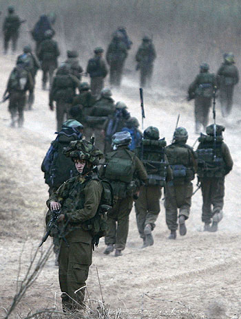Israeli soldiers march inside Lebanon near southern town of Markaba (R)