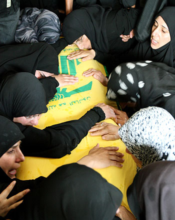 Hezbollah supporters cry over coffin during mass funeral in Deir Qanoun al-Nahr, south Lebanon (R)