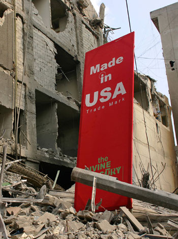 A banner blaming the USA for Israel's month-long offensive on Lebanon is placed near destroyed buildings in the southern suburbs of Beirut (AFP)