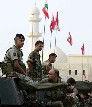 Lebanese soldiers stand guard atop armored personnel carriers in the city of Tyre , Lebanon, 21 August 2006 (EPA)
