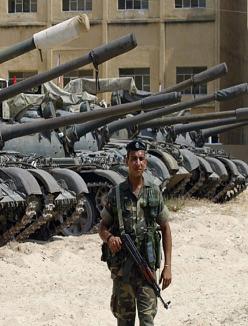 A Lebanese army soldier guards the area among parked Soviet made T-54 tanks in the port city of Tyre(AP)