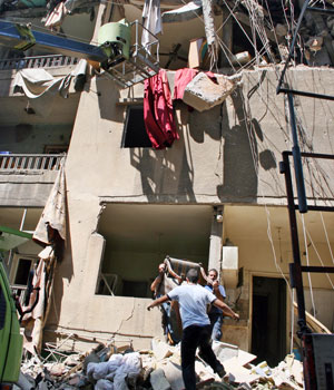 Residents recover furniture from their destroyed apartment in the Hezbollah strongholds of southern suburbs of Beirut, Lebanon, August 23, 2006 (AP)