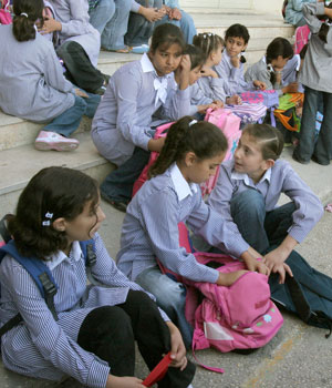 Palestinian school children wait outside a closed school in the West Bank town of Nablus, Sept. 2, 2006 (AP)