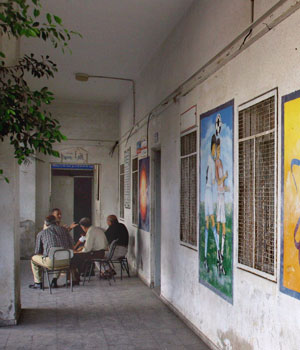 Palestinian teachers on strike sit outside closed classrooms at a school in Gaza City, Sept. 2, 2006 (AP)