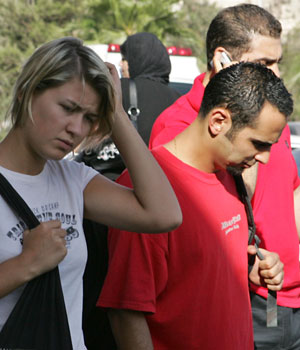 An unidentified tourist, left, leaves an Amman, Jordan, hospital, Sept. 4, 2006 following a attack by a Jordanian gunman who shot at a group of foreign tourists visiting the Roman Amphitheater in Amman (AP)