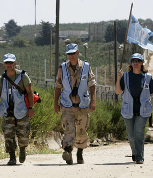 United Nations observers walk along a border near the village of Fatma Gate in southern Lebanon September 6, 2006 (REUTERS)