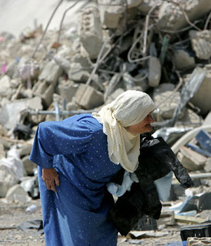 An elderly Lebanese woman walks amongst rubble, Wednesday, Sept. 6, 2006 in the southern Lebanese town of Bint Jbeil (AP)