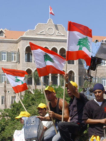 Lebanese fishermen and their families carry the Lebanese flags and take part in a protest outside Government Palace, in Beirut, Lebanon (EPA)