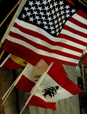 A United State flag flutters among Lebanese flags at a grocery shop in the Lebanese city of Jounieh, east of Beirut (AFP)