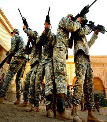 This photo released by the US Army shows US Army soldiers simulating a breach of a house for Iraqi army soldiers (AFP)