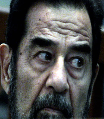 Former Iraqi president Saddam Hussein sits in the dock as his trial on genocide charges resumes (AFP)