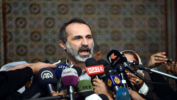 Moaz Alkhatib talks to the press following his meeting with Arab League Secretary General Nabil ElAraby (not seen) in the League headquarters in Cairo on February 11, 2013. (AFP)