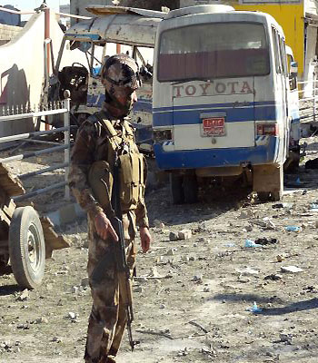 An Iraqi security officer inspects the site of an explosion on January 16, 2013 in Kirkuk, 240 kilometres (150 miles) north of Baghdad.(AFP)