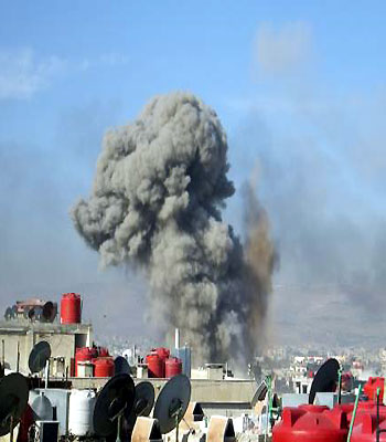 Smoke rises after what activists said were missiles fired by a Syrian Air Force fighter jet loyal to President al-Assad in Daraya. (R)
