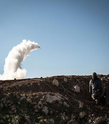 Syrian rebels launch a missile near the Abu Baker brigade in Albab, 30 kilometres from the northeastern Syrian city of Aleppo, on January 16, 2013.(AFP)