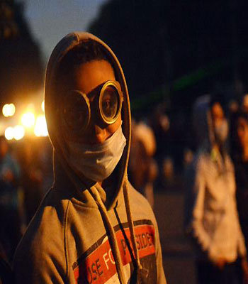An Egyptian protester wearing glasses for protection attends a demonstration near Cairo's Tahrir Square on January 28, 2013. (AFP)