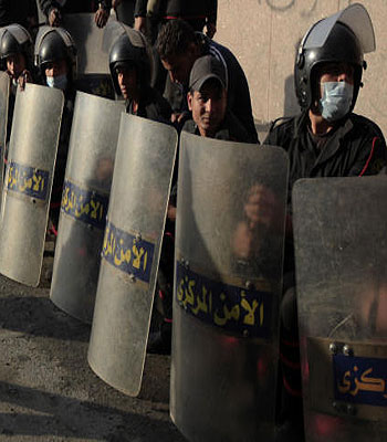 Egyptian riot police rest during clashes with anti-government protesters, not seen, near Tahrir Square, Cairo, Egypt. (AP)