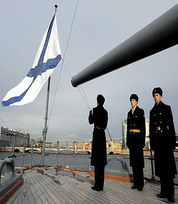 A seaman lowers the Russian navy flag to half-mast as part of a ceremony marking the anniversary of the end of the World War I aboard the legendary cruiser Aurora in St. Petersburg. (AFP)