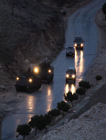 Vehicles of the Lebanese army drive near the village of Arsal, near the border with Syria, where a clash between gunmen and the army happened killing two soldiers on February 1, 2013. (AFP)