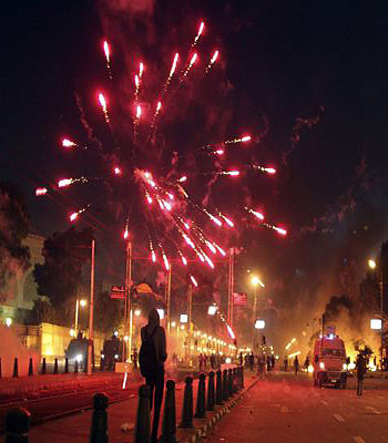 Protesters throw fireworks at police during clashes in front of the presidential palace in Cairo  . (R)