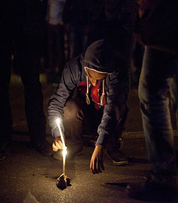 A demonstrator lights candles in memory of protester Mohammed Qorany at the spot where he died in clashes, near the presidential palace in Cairo. (AP)