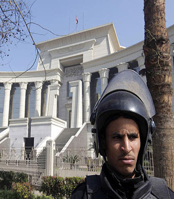An Egyptian anti-riot soldier stands guard in front of the high constitutional court in Cairo, Egypt, Sunday, Feb. 3, 2013. (AP)