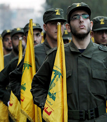 In this 2010 file photo, Hezbollah fighters hold their party flags during a parade in Beirut. (AP)