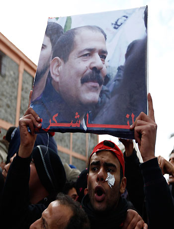 A placard with an image of the late secular opposition leader Chokri Belaid is displayed during his funeral procession in the Jebel Jelloud district in Tunis February 8, 2013. (Reuters)