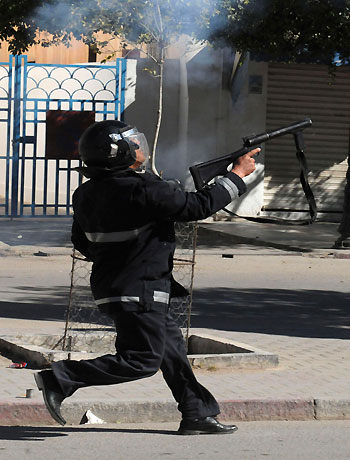 A police officer fires teargas to break up a protest in Gafsa February 7, 2013. (Reuters)