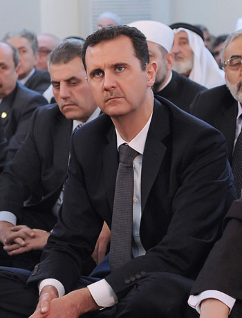 Syria's President Bashar al-Assad attends prayers during celebrations of Prophet Mohammed's Birthday, at the al-Afram mosque in Damascus January 24, 2013, in this handout picture provided by Syria's national news agency SANA. (Reuters)