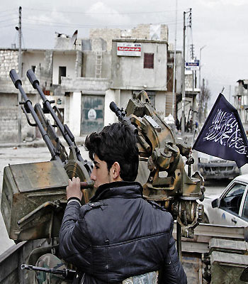 In this Friday February 8, 2013, photo, a Free Syrian Army fighter sits behind an anti-aircraft weapon in Aleppo, Syria.(AP)