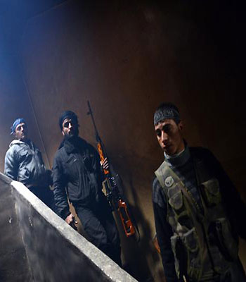 Rebel fighters walks down the stairs to take position to fight against pro-government forces in Izaa district in the Syria's northern city of Aleppo. (AFP)