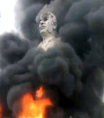 A statue of Hafez Assad, father of Bashar Assad, burns after being set on fire by rebel fighters inside the grounds of the General Company of the Euphrates Dam in Al-Raqqa, Syria. (AP)