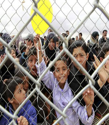 Syrian children, who are refugees, wait for school gates to be opened at Al- Zaatri refugee camp. (R)
