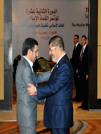 Egyptian President Mohamed Mursi (R) greets Iran's President Mahmoud Ahmadinejad before the opening of the Organisation of Islamic Cooperation (OIC) summit in Cairo February 6, 2013. (Reuters)