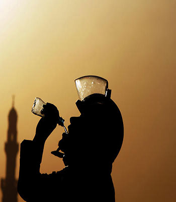 A riot policeman drinks water during clashes with Bahraini anti-government protesters in Daih, Bahrain, Saturday, Feb. 16, 2013. (AP)