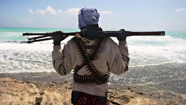 An armed pirate stands on the coastline at Hobyo town in northeastern Somalia. Source: Mohamed Dahir/AFP/Getty Image