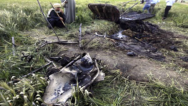 Night watchmen guard the wreckage of a hot air balloon that crashed in Luxor. (R)