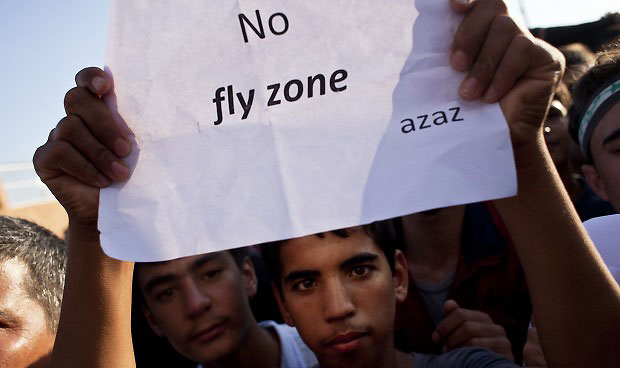 A young Syrian protester holds a sign calling for a no-fly zone during a demonstration in support of the Free Syrian Army near the Syrian–Turkish border crossing of Al-Salama on September 7, 2012. Source: ACHILLEAS ZAVALLIS/AFP/Getty Images