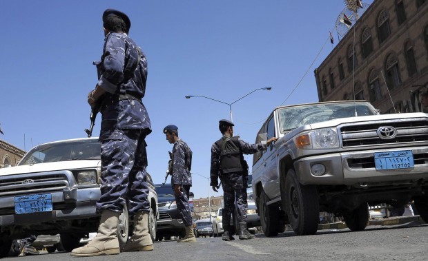 Police troopers search cars in Sanaa March 15, 2013. (REUTERS/Khaled Abdullah)