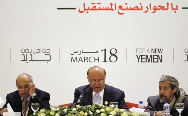 Yemen's President Abd Rabbo Mansour Hadi (C) speaks next to members of the dialogue committee during the first opening session of a national dialogue conference in Sanaa March 19, 2013. (REUTERS/Mohamed al-Sayaghi)