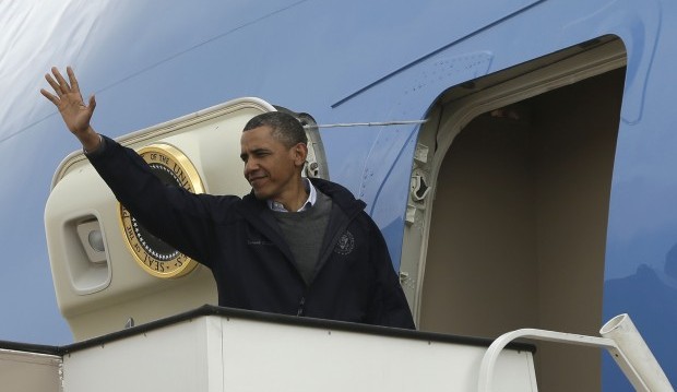 U.S. President Barack Obama waves from Air Force One as he leaves Jordan at the Queen Alia International Airport in Amman Saturday, March 23, 2013. (AP Photo/Pablo Martinez Monsivais)