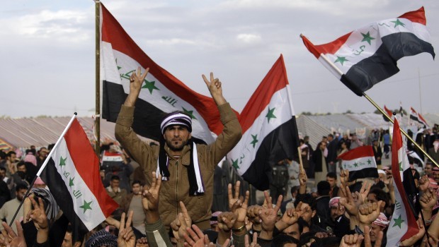 In this Wednesday, Jan. 9, 2013 file photo, protesters chant slogans against Iraq's Shiite-led government as they wave national flags during a demonstration in Ramadi, Iraq, 70 miles (115 kilometers) west of Baghdad. (AP Photo/Khalid Mohammed, File)
