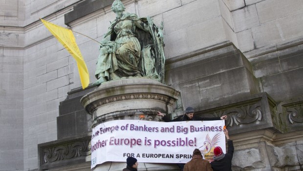 A banner erected by protestors during a tripartite-social summit meeting at the EU Council building  in Brussels on Thursday, March 14, 2013. Source: AP Photo/Virginia Mayo