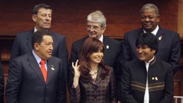 Argentina's President Cristina Fernandez, front center, gestures as Venezuela's President Hugo Chavez,front left, and Bolivia's President Evo Morales, front right, smiles during the inauguration ceremony of Ecuador's President Rafael Correa at the National Assembly in Quito, Monday, Aug. 10, 2009. The three men behind are unidentified. (AP Photo/Martin Mejia)