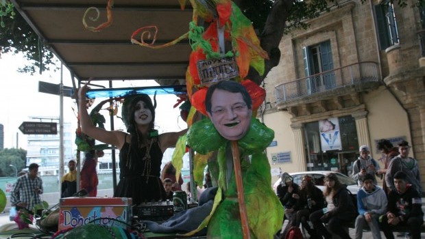 A cut-out image of Cypriot President Nicos Anastasiades decorates a DJ stand as part of carnival celebrations in Nicosia on March 16, 2013. (AFP PHOTO/HASAN MROUE)