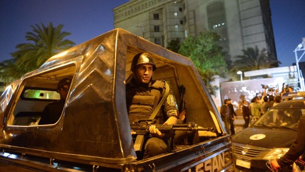 An Egyptian policeman keeps watch outside the offices where Libyan Ahmed Kadhaf al-Damm (R) is having a hearing after being arrested in Cairo on March 19, 2013. Source: AFP PHOTO / KHALED DESOUKI