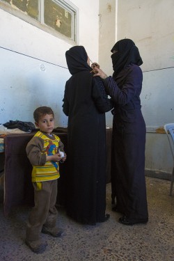 A volunteer treating a patient for symptoms of Leishmaniasis at a makeshift clinic in Aleppo. (Asharq Al-Awsat photo)